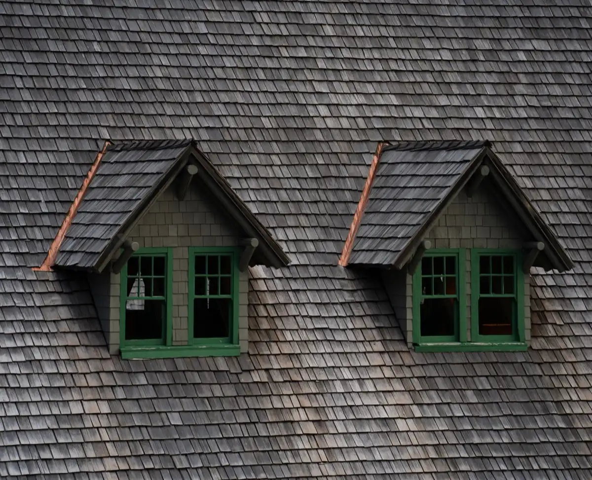 Dormers on a shingle roof in Winter Haven, FL, where step flashing and kickout flashing carry water past the walls